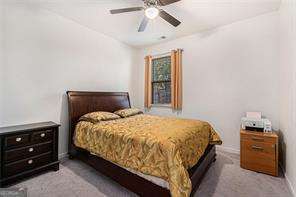 121 Royal Sunset Dr, Dallas, GA 30157 - carpeted bedroom featuring baseboards and ceiling fan