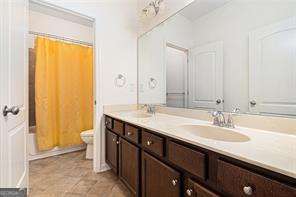 121 Royal Sunset Dr, Dallas, GA 30157 - full bath with double vanity, toilet, and shower / bathtub combination with curtain