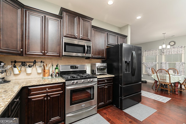 2256 Long Bow Chase NW, Kennesaw, GA 30144 - kitchen with stainless steel appliances, dark brown cabinets, dark wood finished floors, tasteful backsplash, and recessed lighting
