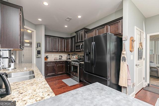 2256 Long Bow Chase NW, Kennesaw, GA 30144 - kitchen featuring appliances with stainless steel finishes, dark wood-type flooring, dark brown cabinets, recessed lighting, and a sink