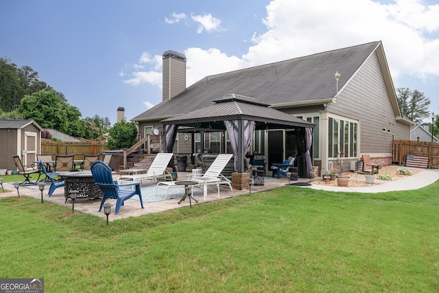 2256 Long Bow Chase NW, Kennesaw, GA 30144 - rear view of house featuring a gazebo, a patio area, an outdoor fire pit, and a chimney