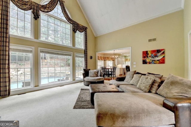 5980 Whitestone Ln, Suwanee, GA 30024 - living room featuring high vaulted ceiling, ornamental molding, carpet flooring, and a chandelier