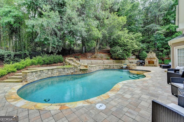 5980 Whitestone Ln, Suwanee, GA 30024 - view of swimming pool with an outdoor stone fireplace and a patio