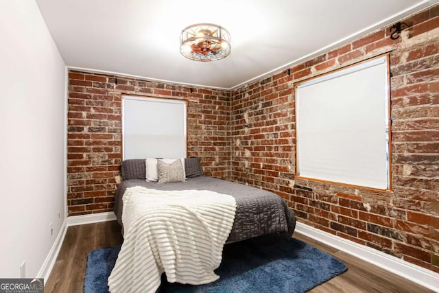40 Daniel St SE, Atlanta, GA 30312 - bedroom featuring baseboards, brick wall, and wood finished floors