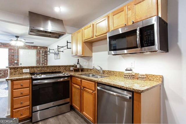 40 Daniel St SE, Atlanta, GA 30312 - kitchen with appliances with stainless steel finishes, wall chimney exhaust hood, a peninsula, dark wood-style floors, and a sink
