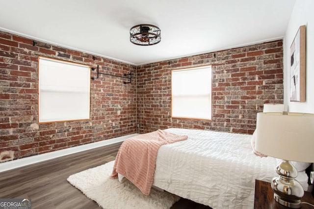 40 Daniel St SE, Atlanta, GA 30312 - bedroom with baseboards, wood finished floors, and brick wall