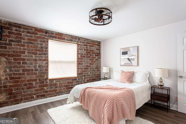 40 Daniel St SE, Atlanta, GA 30312 - bedroom featuring baseboards, wood finished floors, and brick wall