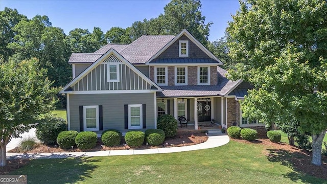 1917 Hearthstone Ct, Winder, GA 30680 - craftsman-style house with a front lawn, a porch, board and batten siding, and stone siding