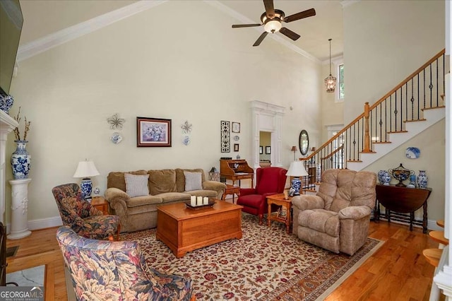 1917 Hearthstone Ct, Winder, GA 30680 - living area with ceiling fan, high vaulted ceiling, wood finished floors, stairs, and baseboards