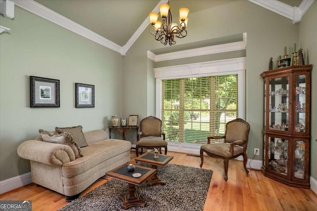 1917 Hearthstone Ct, Winder, GA 30680 - living area with lofted ceiling, a chandelier, ornamental molding, and light wood-style flooring