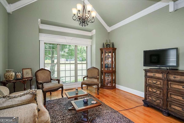 1917 Hearthstone Ct, Winder, GA 30680 - living area with vaulted ceiling, a chandelier, light wood-style flooring, crown molding, and baseboards