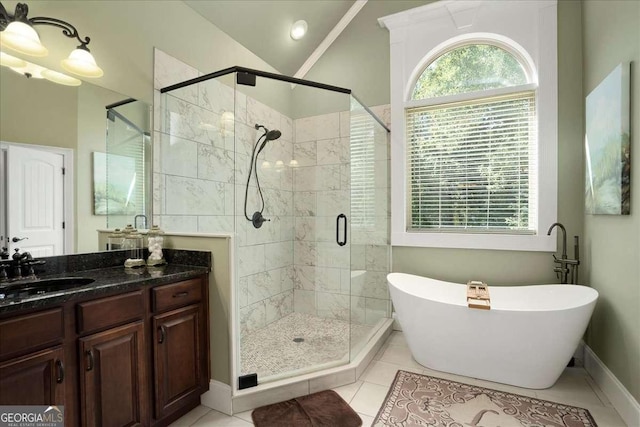 1917 Hearthstone Ct, Winder, GA 30680 - bathroom featuring a soaking tub, a stall shower, vanity, tile patterned flooring, and vaulted ceiling