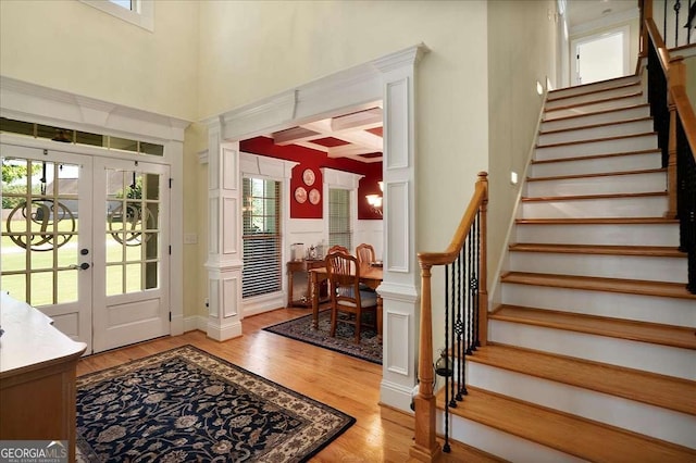 1917 Hearthstone Ct, Winder, GA 30680 - entrance foyer featuring healthy amount of natural light, stairs, light wood-type flooring, coffered ceiling, and beam ceiling