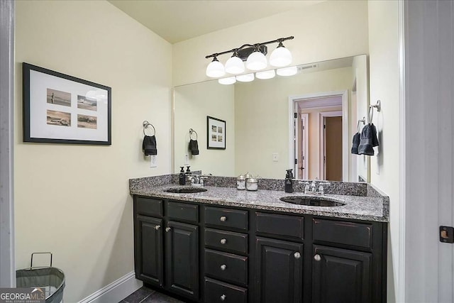 1917 Hearthstone Ct, Winder, GA 30680 - full bathroom featuring double vanity and baseboards