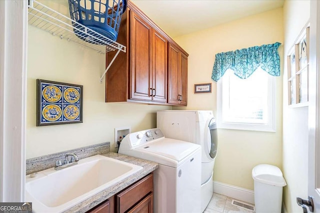 1917 Hearthstone Ct, Winder, GA 30680 - laundry room with independent washer and dryer, cabinet space, baseboards, and light tile patterned floors