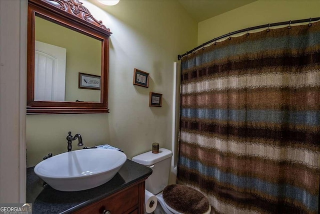 1917 Hearthstone Ct, Winder, GA 30680 - bathroom with vanity, toilet, and curtained shower