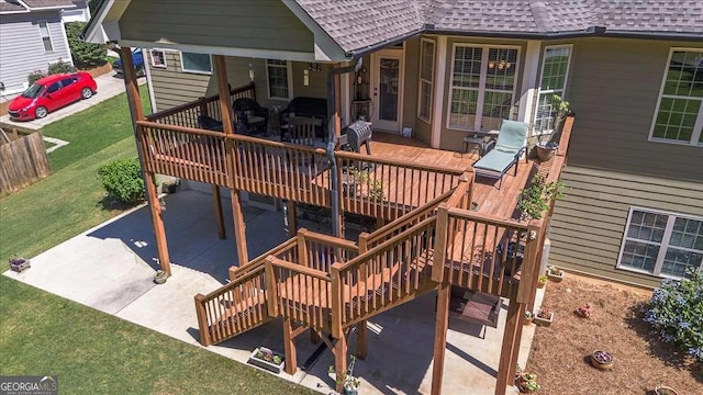 1917 Hearthstone Ct, Winder, GA 30680 - deck with stairs, a patio area, and a yard