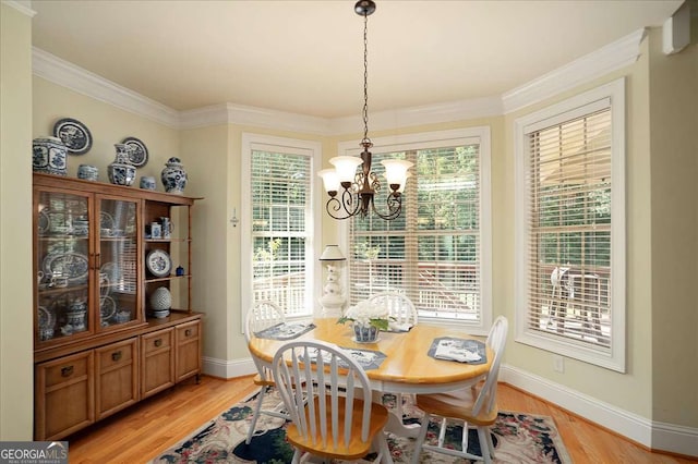 1917 Hearthstone Ct, Winder, GA 30680 - dining room featuring a chandelier, baseboards, light wood-style flooring, and ornamental molding