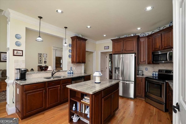 1917 Hearthstone Ct, Winder, GA 30680 - kitchen with appliances with stainless steel finishes, a sink, tasteful backsplash, hanging light fixtures, and light stone countertops