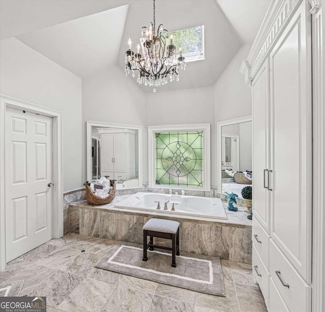 162 Daltree Ct, Marietta, GA 30068 - bathroom featuring high vaulted ceiling, a garden tub, marble finish floors, and a chandelier