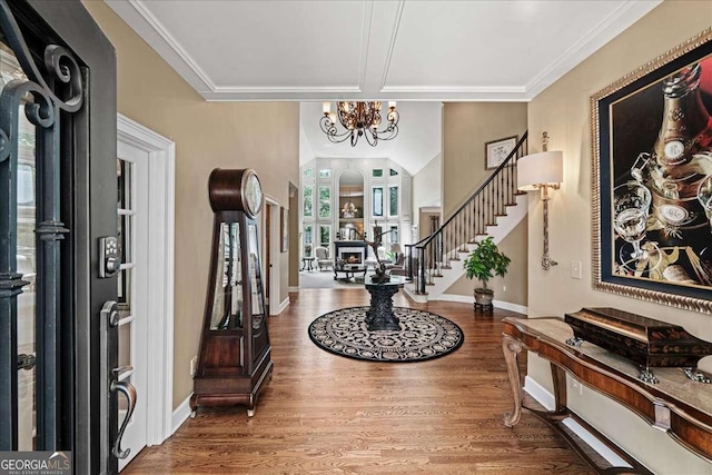 162 Daltree Ct, Marietta, GA 30068 - foyer entrance featuring stairs, wood finished floors, a chandelier, and ornamental molding