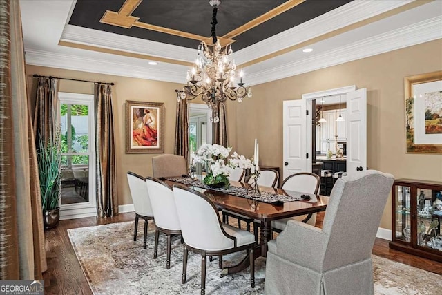 162 Daltree Ct, Marietta, GA 30068 - dining room featuring a raised ceiling, a chandelier, wood finished floors, and crown molding