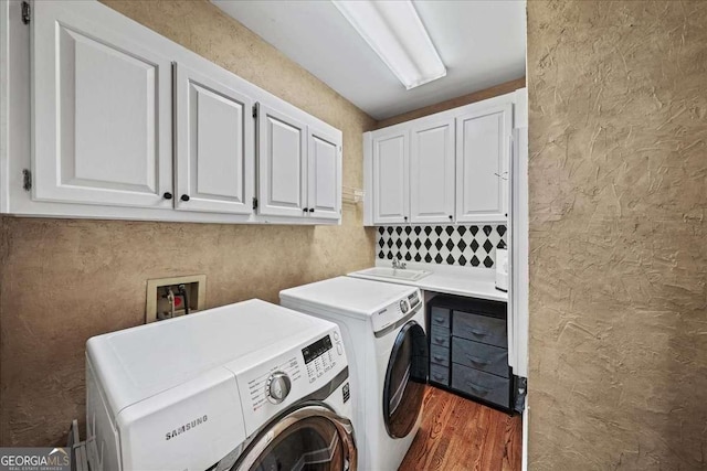 162 Daltree Ct, Marietta, GA 30068 - laundry room with cabinet space, washing machine and clothes dryer, wood finished floors, and a textured wall