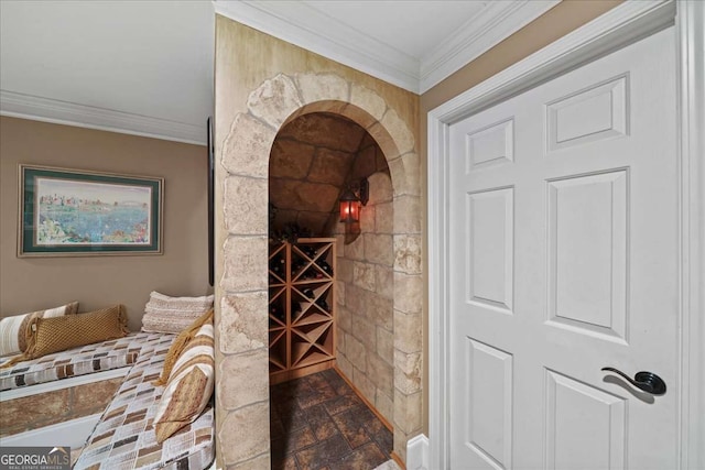 162 Daltree Ct, Marietta, GA 30068 - wine area featuring crown molding, dark stone finish flooring, and arched walkways