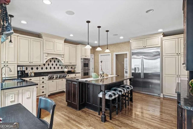 162 Daltree Ct, Marietta, GA 30068 - kitchen with appliances with stainless steel finishes, cream cabinets, a center island, and recessed lighting