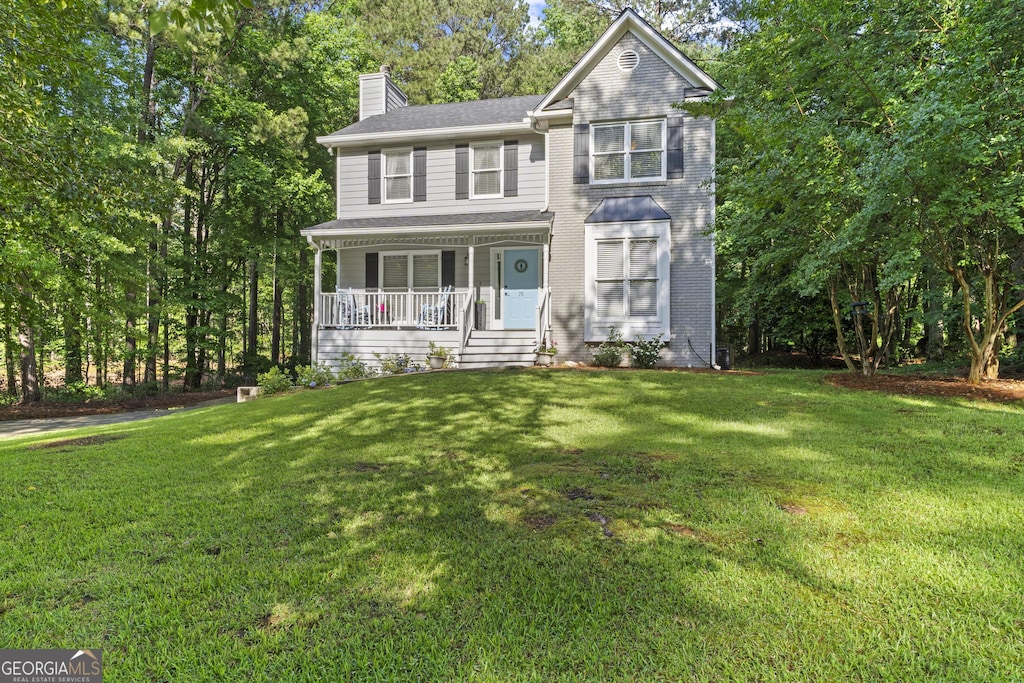75 Chatsworth Pl, Newnan, GA 30265 - view of front of property featuring covered porch, a chimney, and a front lawn
