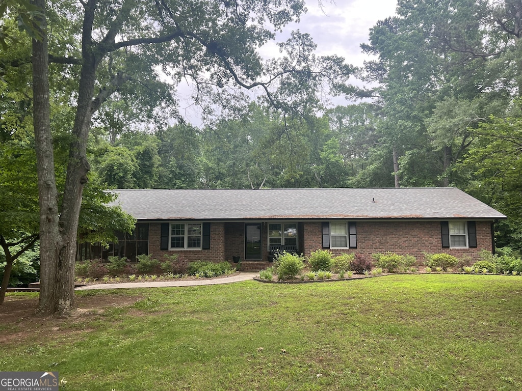 226 Baker St, Statham, GA 30666 - ranch-style home featuring a front lawn and brick siding