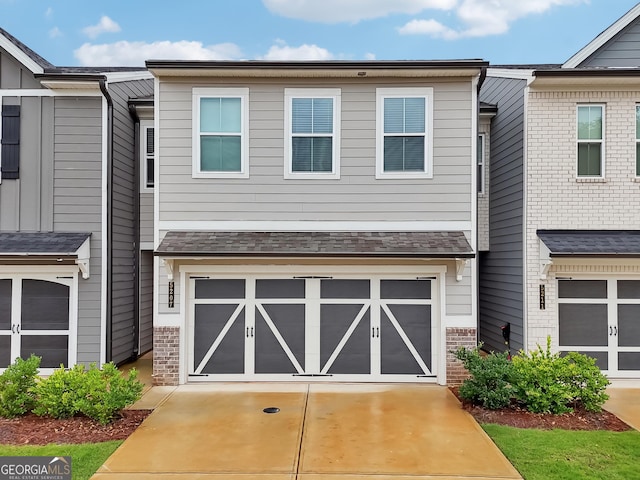 5207 Canberra Dr, Flowery Branch, GA 30542 - townhome / multi-family property featuring concrete driveway and an attached garage
