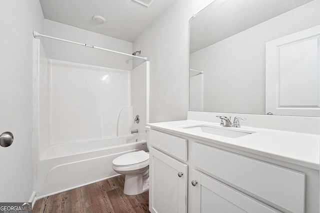 5207 Canberra Dr, Flowery Branch, GA 30542 - full bath featuring wood finished floors, vanity, and bathtub / shower combination