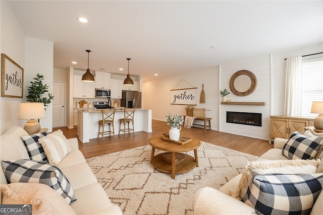 5207 Canberra Dr, Flowery Branch, GA 30542 - living room featuring wood finished floors, recessed lighting, and a fireplace