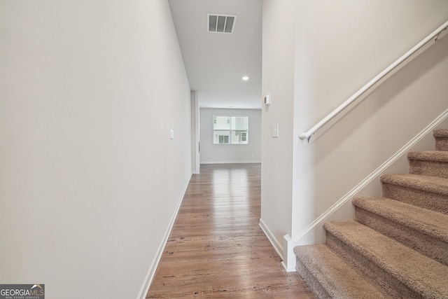 5207 Canberra Dr, Flowery Branch, GA 30542 - hall featuring stairs, light wood-type flooring, and recessed lighting