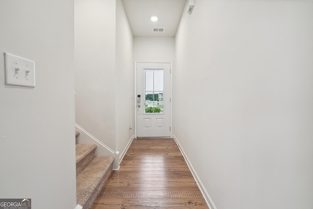 5207 Canberra Dr, Flowery Branch, GA 30542 - doorway with wood finished floors and stairway