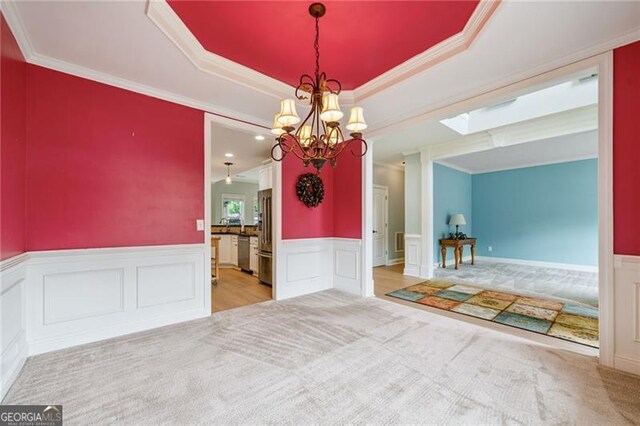 1210 Magnolia Park Cir, Cumming, GA 30040 - unfurnished dining area featuring a chandelier, ornamental molding, a wainscoted wall, a decorative wall, and carpet