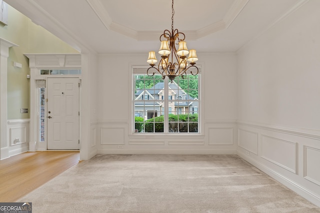 1210 Magnolia Park Cir, Cumming, GA 30040 - unfurnished dining area featuring a chandelier, a raised ceiling, a decorative wall, ornamental molding, and light colored carpet