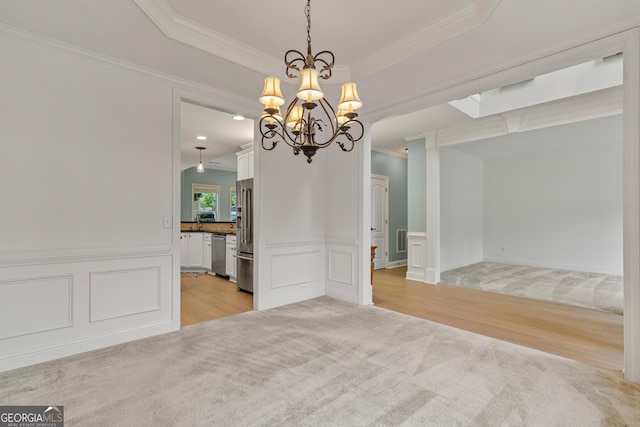 1210 Magnolia Park Cir, Cumming, GA 30040 - unfurnished dining area featuring ornamental molding, light colored carpet, light wood finished floors, a chandelier, and a decorative wall