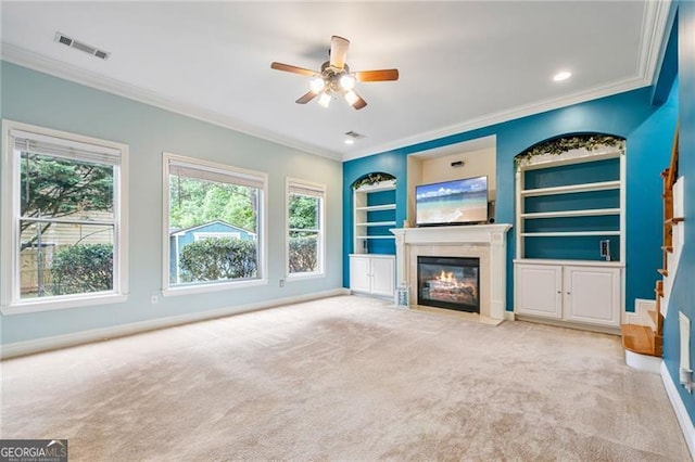 1210 Magnolia Park Cir, Cumming, GA 30040 - unfurnished living room featuring crown molding, carpet floors, built in features, a ceiling fan, and a fireplace with flush hearth