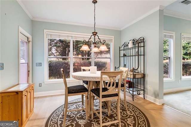 1210 Magnolia Park Cir, Cumming, GA 30040 - dining room with light wood-style flooring, plenty of natural light, baseboards, crown molding, and a chandelier