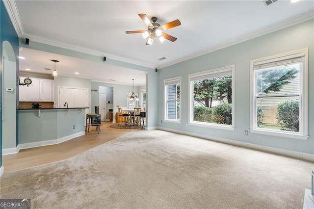 1210 Magnolia Park Cir, Cumming, GA 30040 - living room featuring light carpet, ornamental molding, a ceiling fan, and recessed lighting