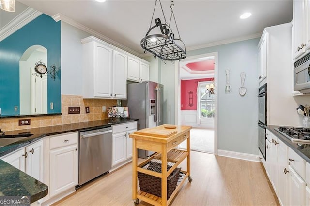 1210 Magnolia Park Cir, Cumming, GA 30040 - kitchen featuring stainless steel appliances, light wood-type flooring, white cabinetry, arched walkways, and ornamental molding
