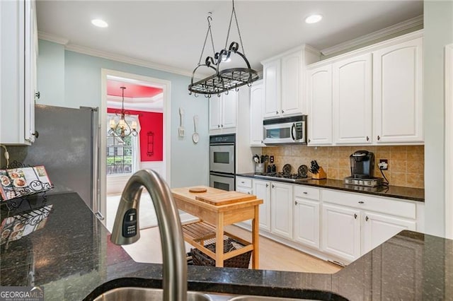 1210 Magnolia Park Cir, Cumming, GA 30040 - kitchen with stainless steel appliances, white cabinetry, ornamental molding, decorative backsplash, and recessed lighting