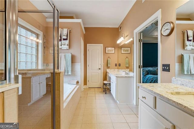 1210 Magnolia Park Cir, Cumming, GA 30040 - ensuite bathroom featuring two vanities, a bath, tile patterned flooring, crown molding, and a shower stall