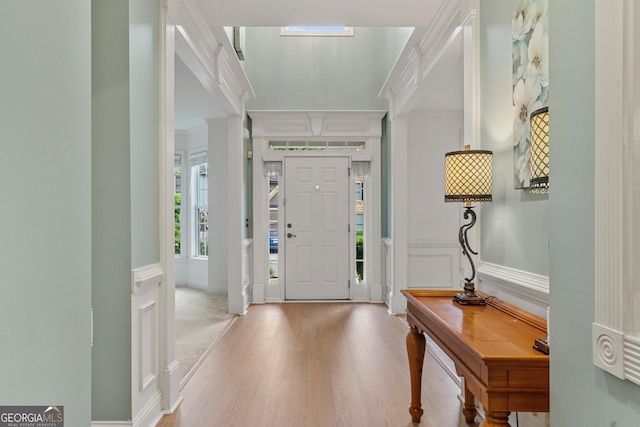 1210 Magnolia Park Cir, Cumming, GA 30040 - entrance foyer featuring wood finished floors, ornamental molding, and a decorative wall