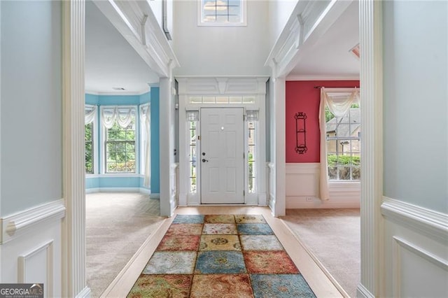 1210 Magnolia Park Cir, Cumming, GA 30040 - foyer featuring crown molding, carpet, plenty of natural light, wainscoting, and a decorative wall