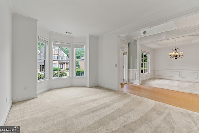 1210 Magnolia Park Cir, Cumming, GA 30040 - spare room with carpet floors, a chandelier, plenty of natural light, ornamental molding, and a decorative wall