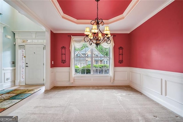 1210 Magnolia Park Cir, Cumming, GA 30040 - unfurnished dining area with a chandelier, a raised ceiling, carpet floors, wainscoting, and a decorative wall