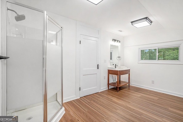 1852 Burwell Rd, Carrollton, GA 30117 - full bathroom featuring a stall shower, wood finished floors, vanity, and baseboards
